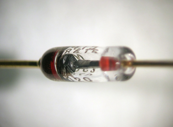 Fig. 1 (Click to enlarge). A traditional semiconductor diode, showing the square-shaped semiconductor crystal. (Wikipedia)