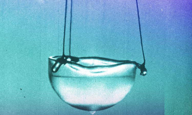Fig. 1 (Click to enlarge). Superfluid helium exhibits many strange behaviors, like spontaneously climbing the sides of its container and spilling out. (BBC)